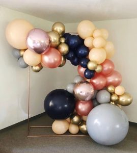 Copper rectangle stand wrapped in balloons available to rent from Just Peachy in Little Rock, Arkansas.