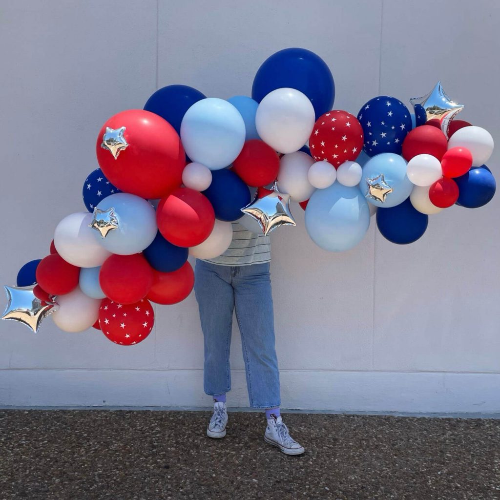 Red, white, dark & light blue balloon garland with silver stars for Fourth of July summer parties from Just Peachy in Little Rock.