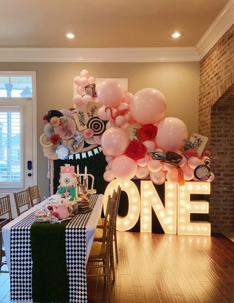 https://doingjustpeachy.com/wp-content/uploads/2022/01/Balloon-Backdrop-and-Marquee-letters-for-Alice-in-Wonderland-first-birthday-party-791x1024.jpg