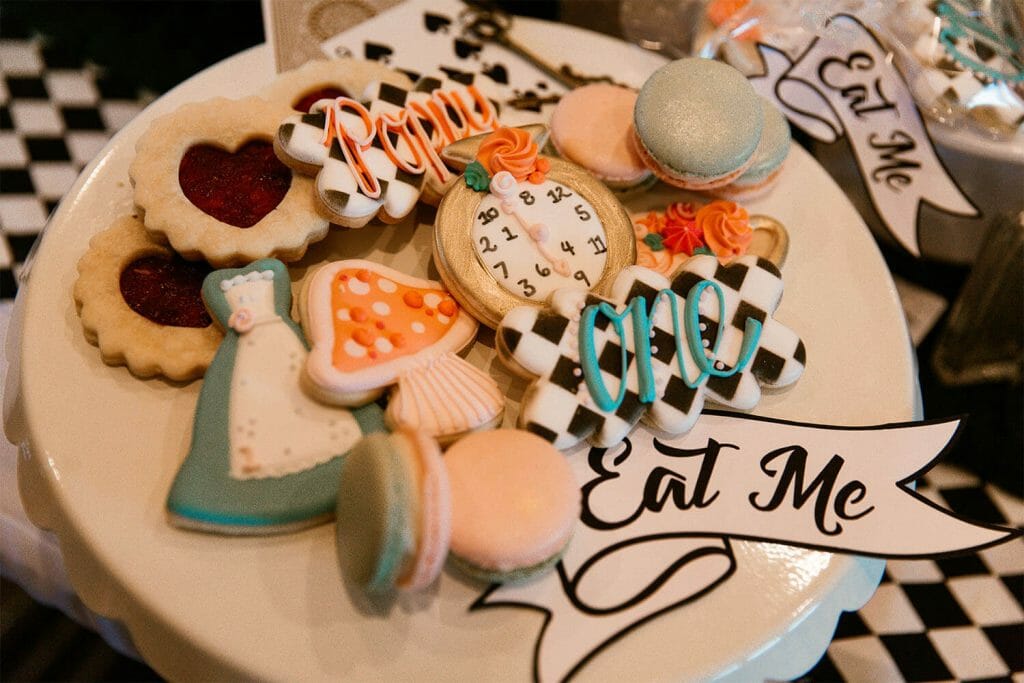 Iced sugar cookies with Alice in Wonderland details: the dress, a mushroom, and black and white checkerboards.