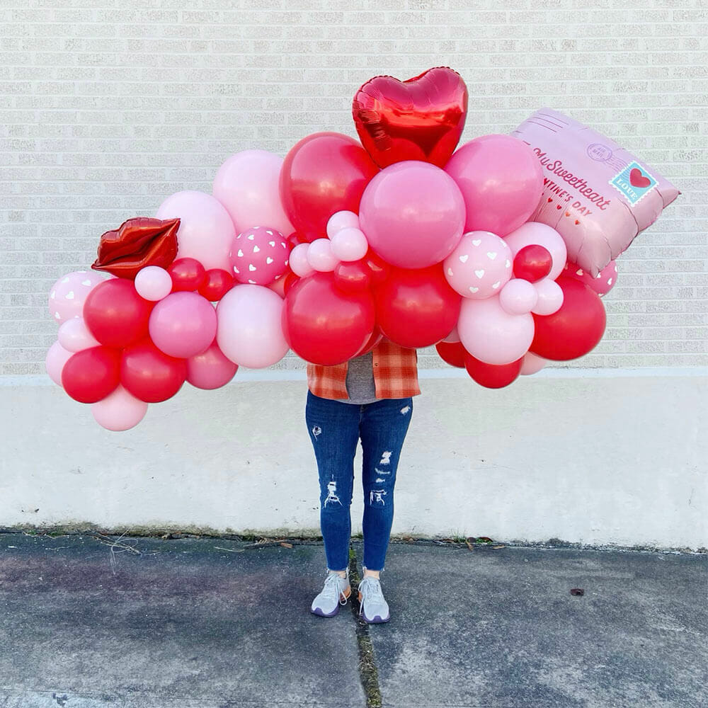 A large balloon garland with heart balloons and lip balloons for Valentine's day